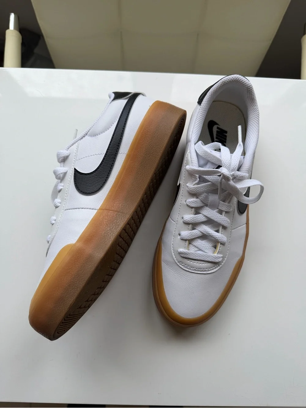 Nike White Leather Sneakers with Black Swoosh and Gum Sole